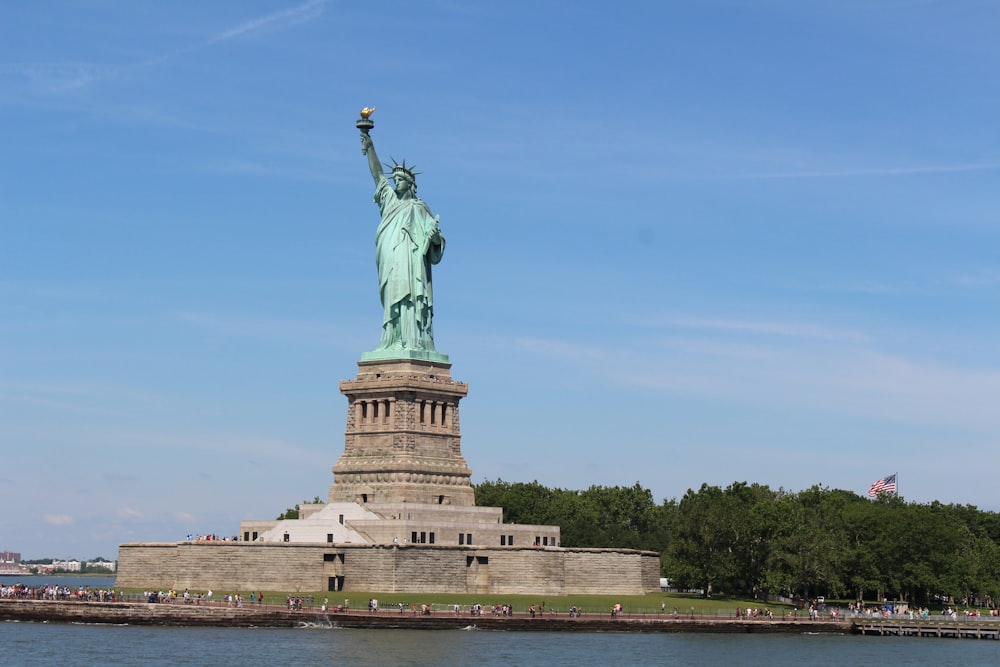 a large statue of a person holding a torch