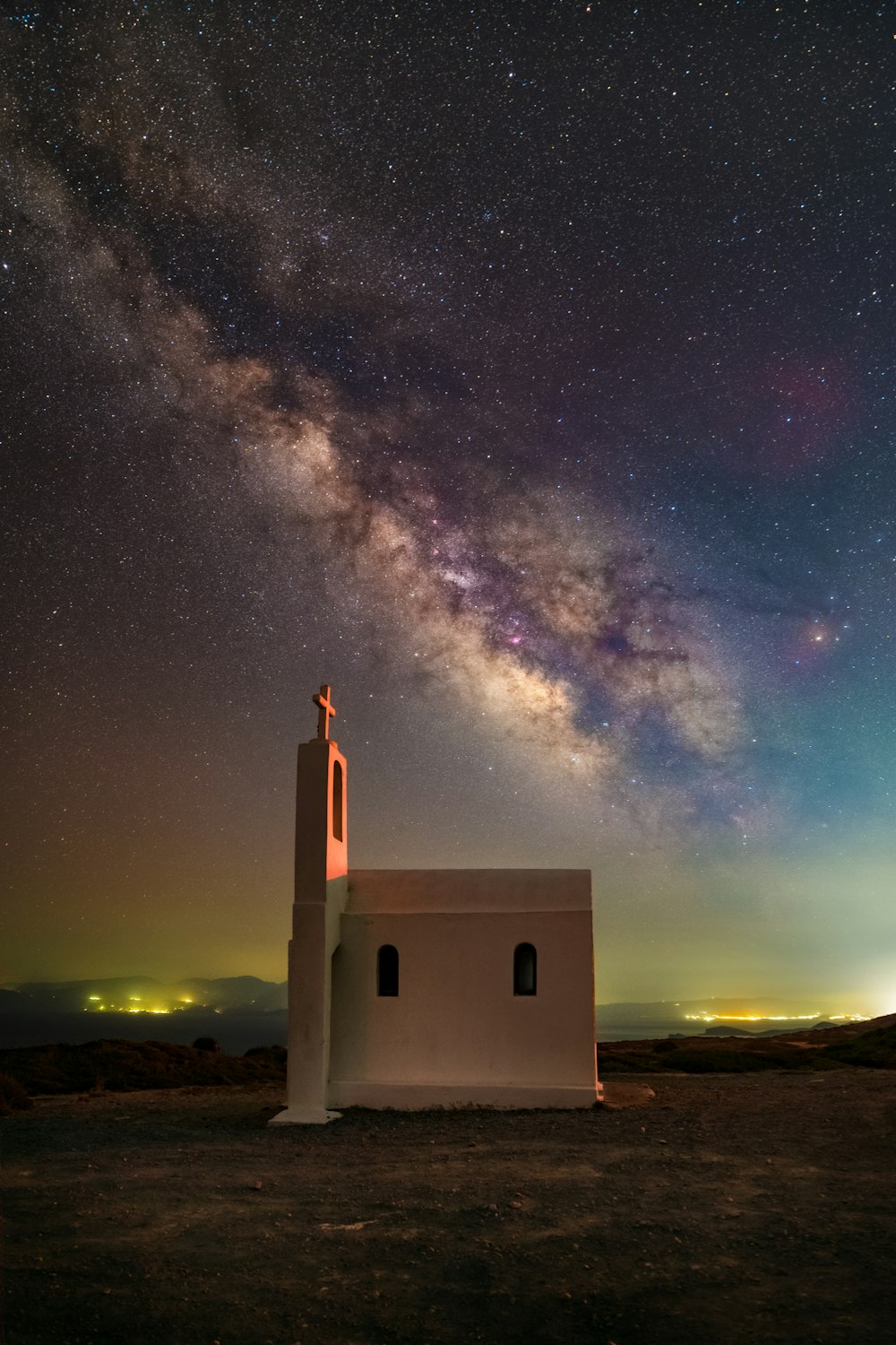 a building with a tower and stars in the sky