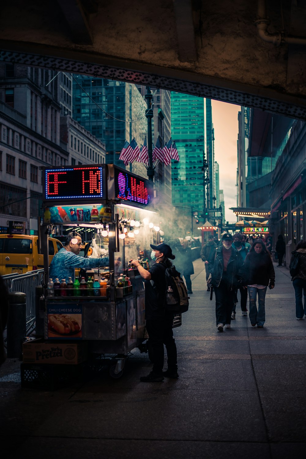 a street with people and food vendors