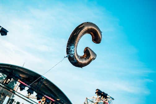 Giant balloon letters spelling a company name at a corporate event.
