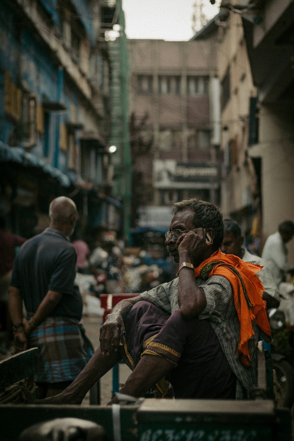 a person sitting on a bench talking on a cell phone