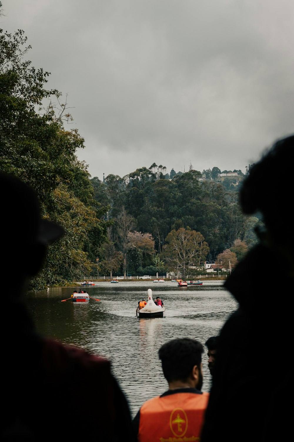 people watching a boat on the water