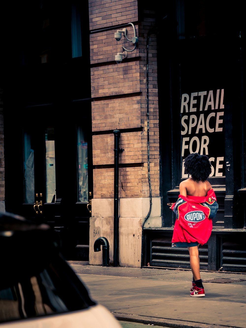 a girl running on a sidewalk