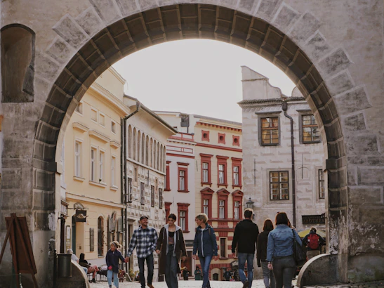 A cozy travel group enjoying a guided tour in a historic city with ancient architecture.