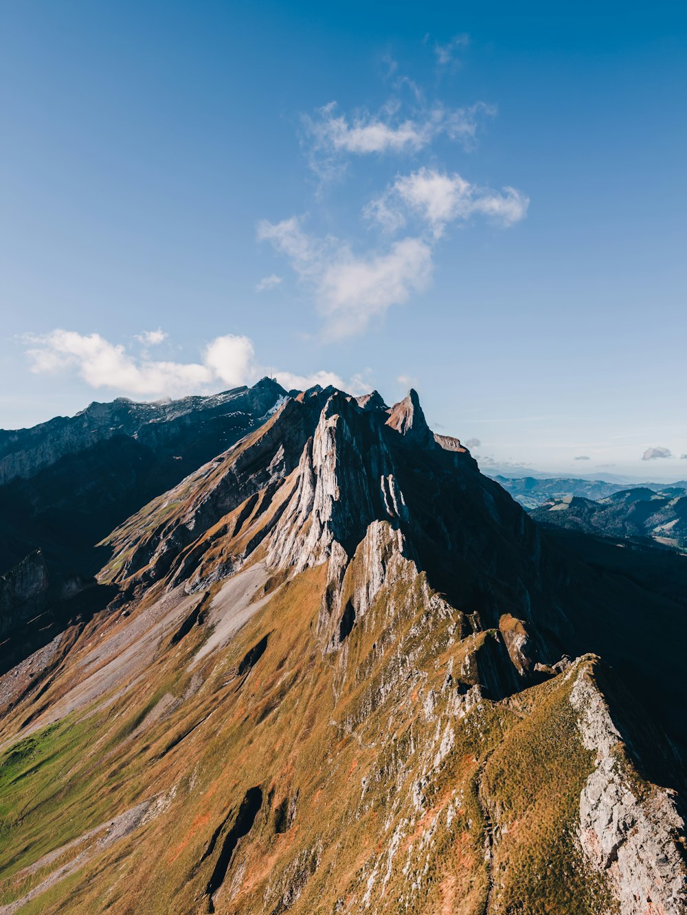 a rocky mountain with a blue sky