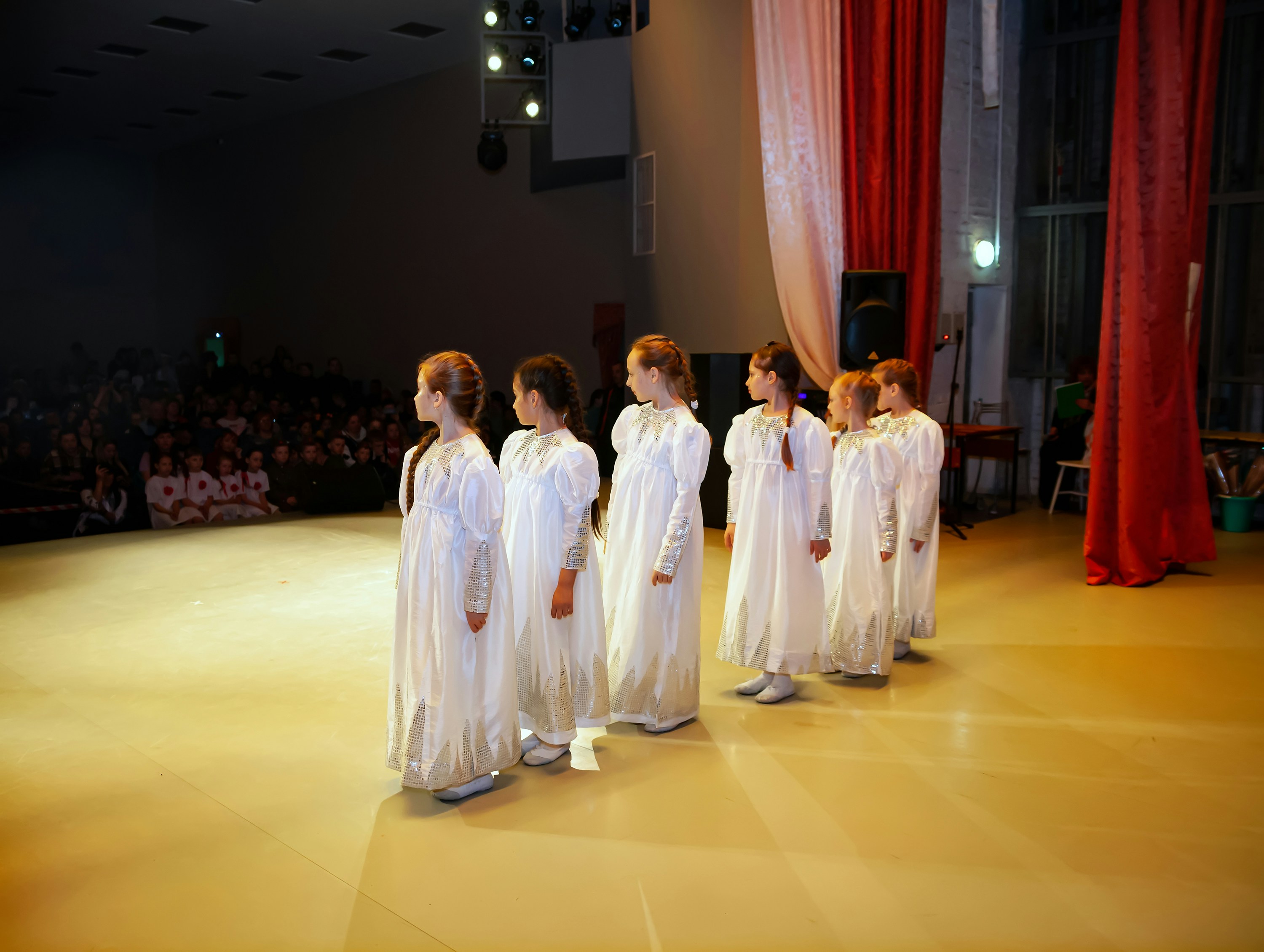a group of women in white dresses