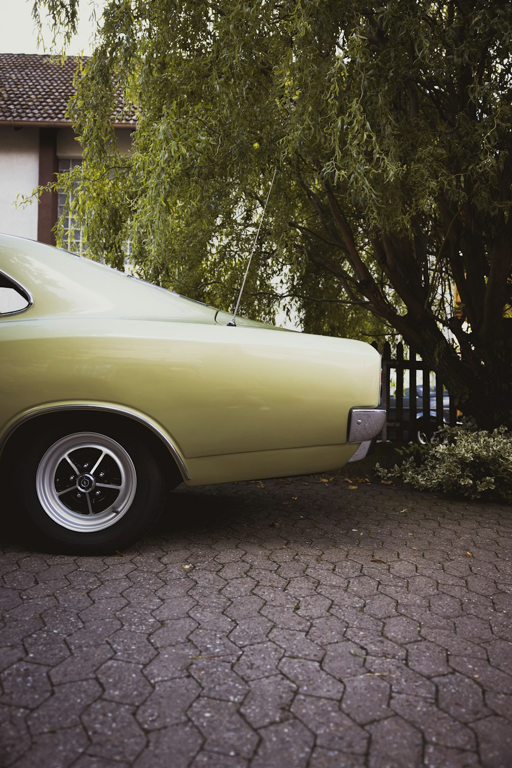 a car parked on a brick driveway