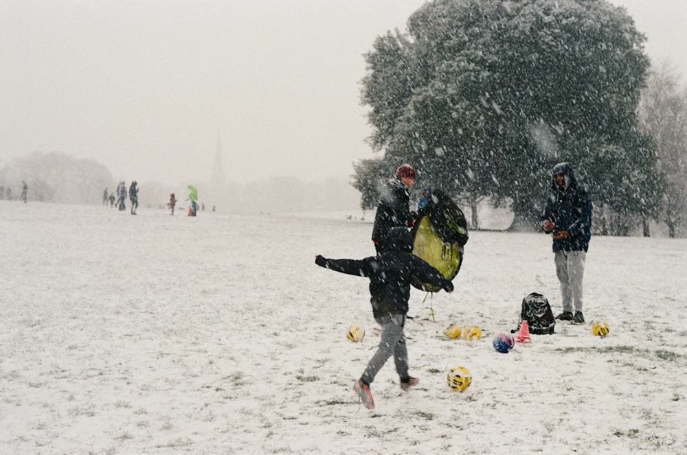 a group of people play in the snow