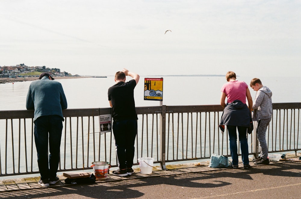 people standing on a pier