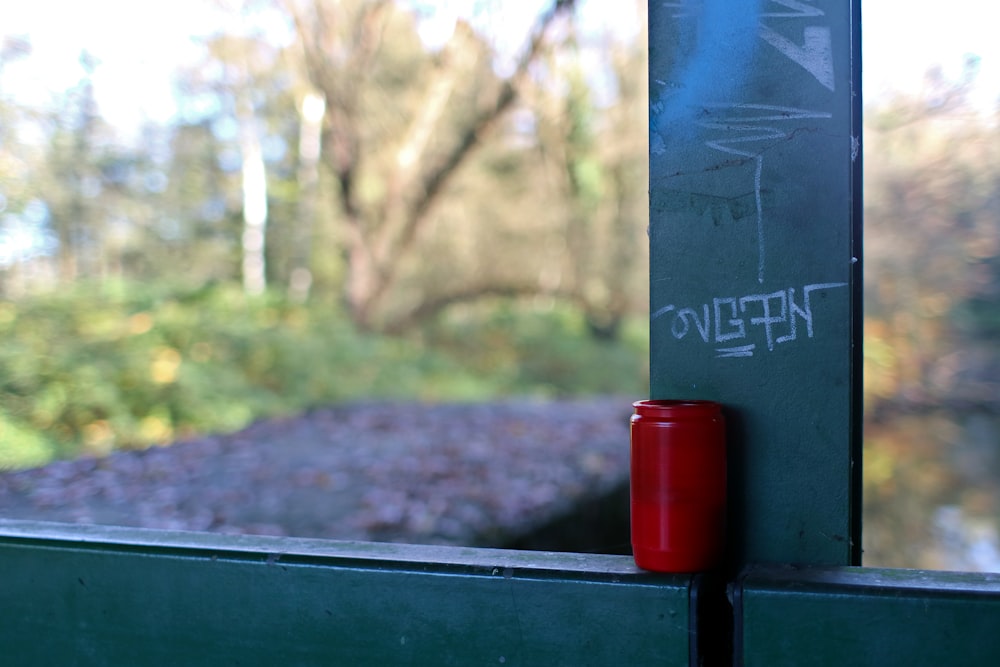 a red and white cylindrical object on a green surface