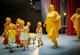 a person in a garment surrounded by children