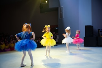 a group of girls dancing on a stage