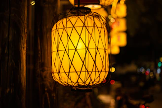 A warm glowing lantern hanging in a peaceful evening garden, symbolizing hope and guidance.