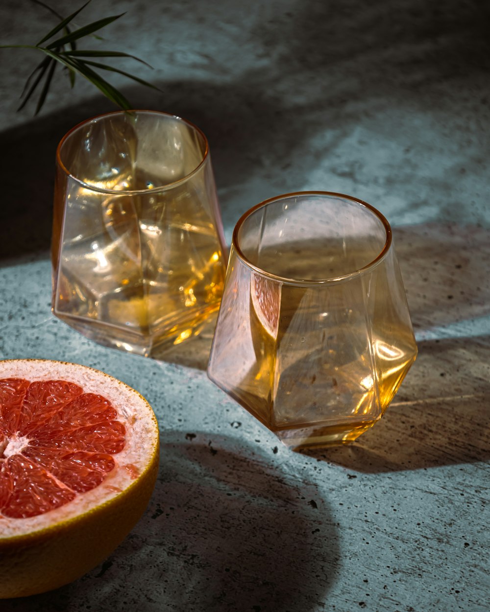 a glass and a fruit on a table