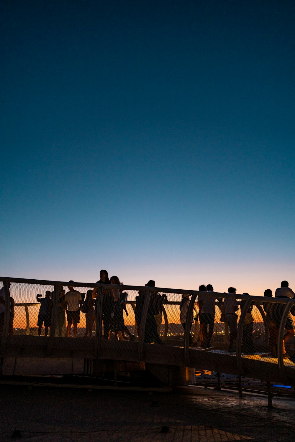 a group of people standing on a bridge