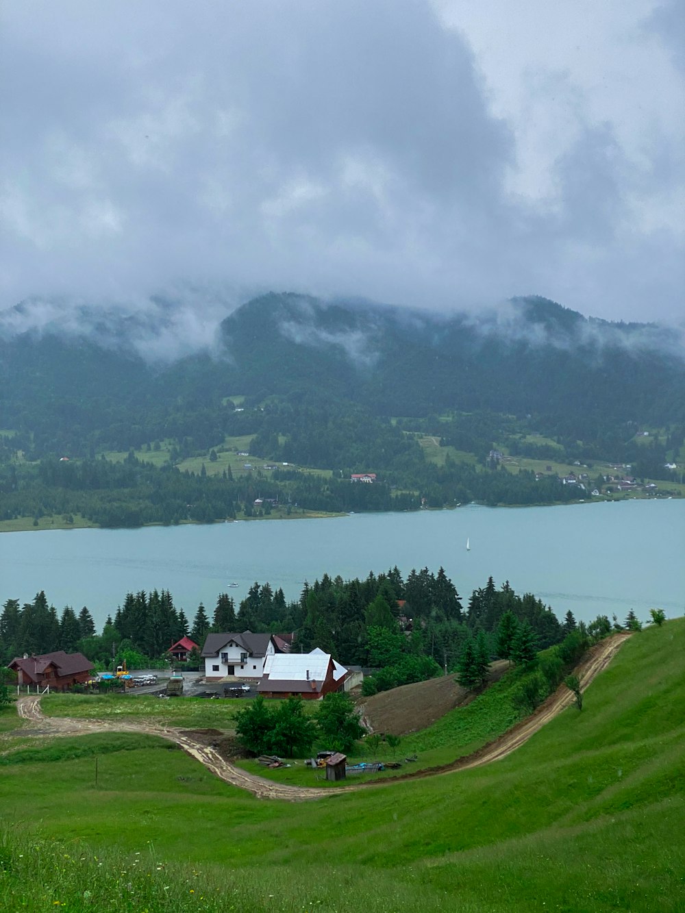 a lake with a house and trees by it