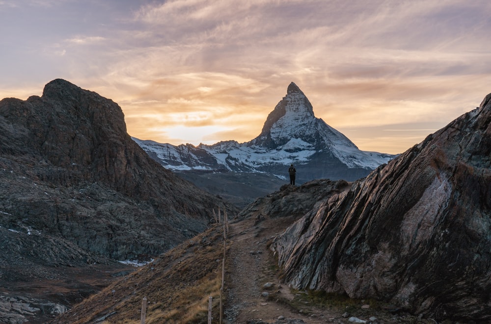 a person standing on a rocky mountain