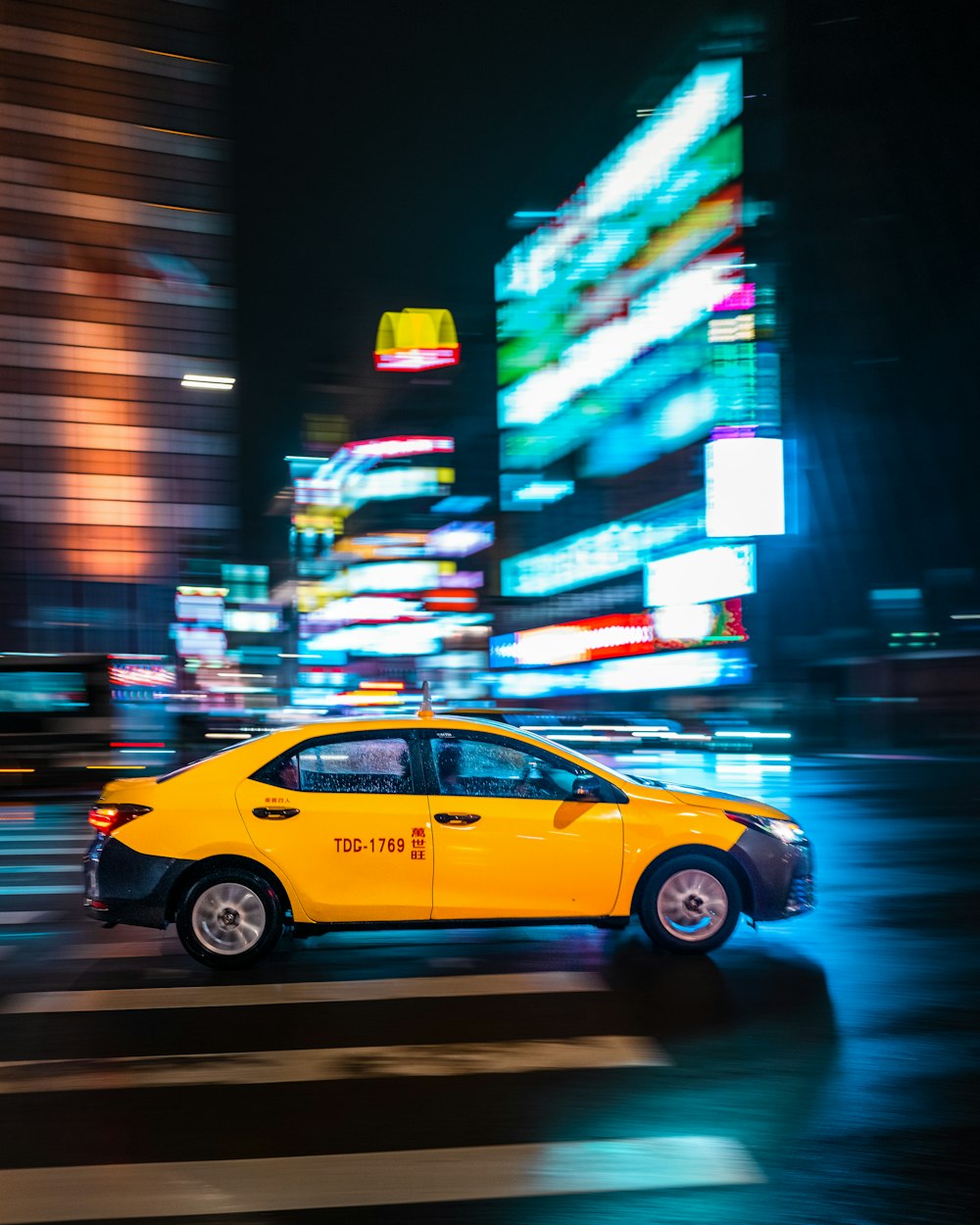a taxi cab on a street at night