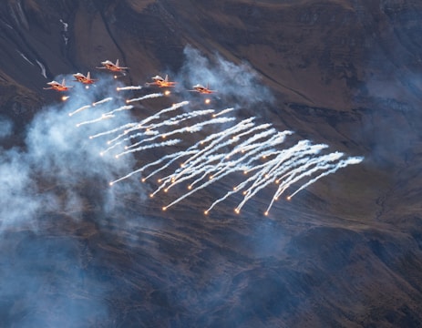 a group of airplanes flying over a city