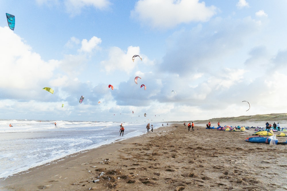 people flying kites on a beach