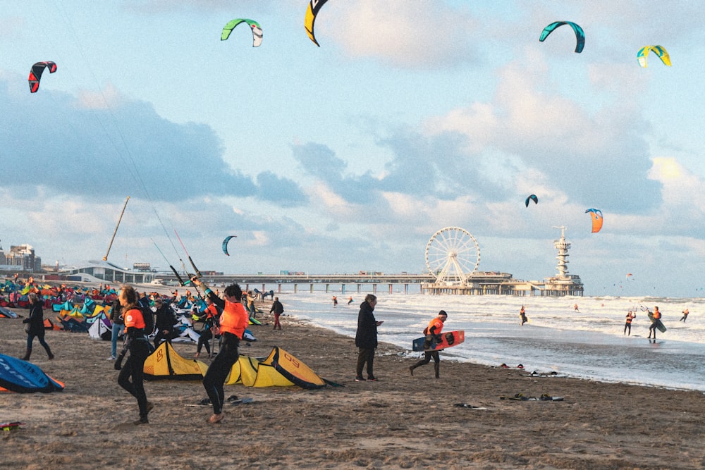 people flying kites on beach