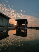 A vibrant sunset over a partially built structure.