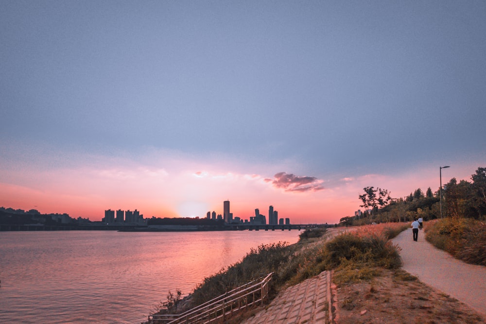 a body of water with a city in the background