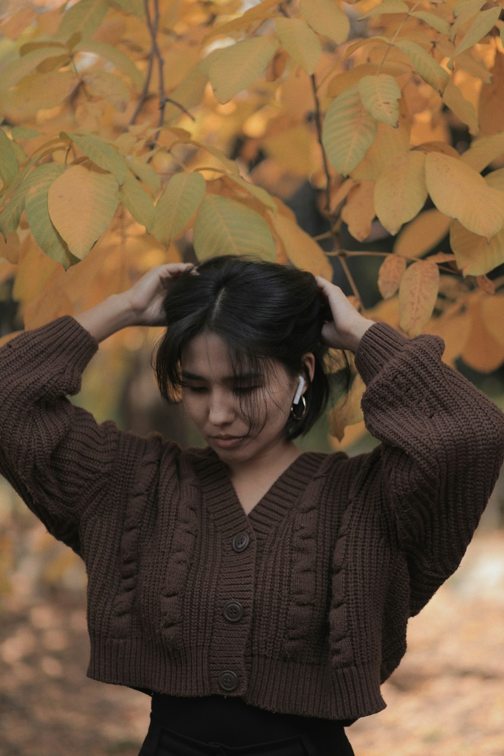 a woman standing under a tree