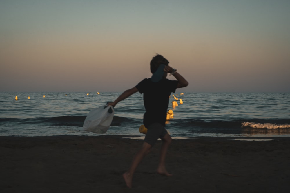 a man holding a fishing pole on a beach