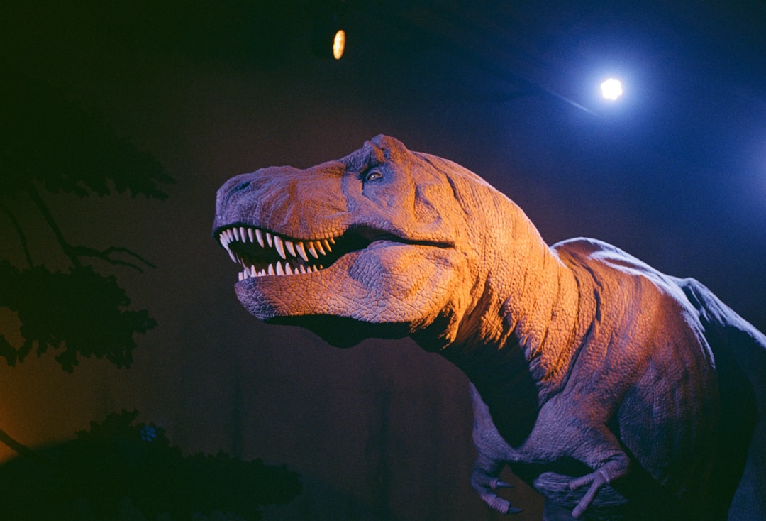 a dinosaur with a moon in the background,