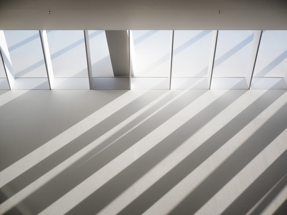 a white tiled room with windows