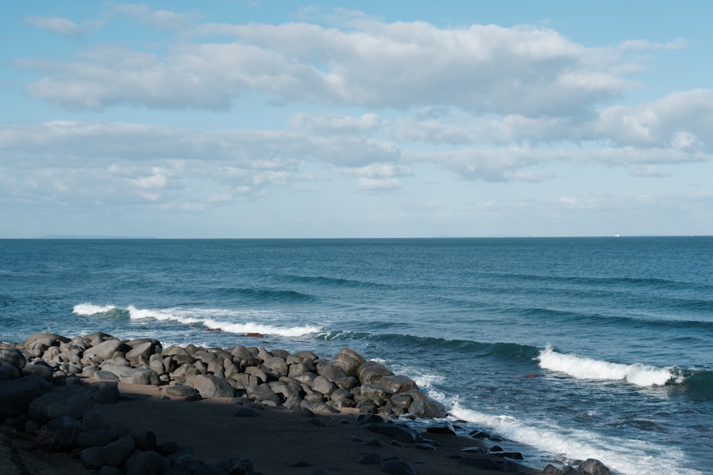 a rocky beach with waves crashing