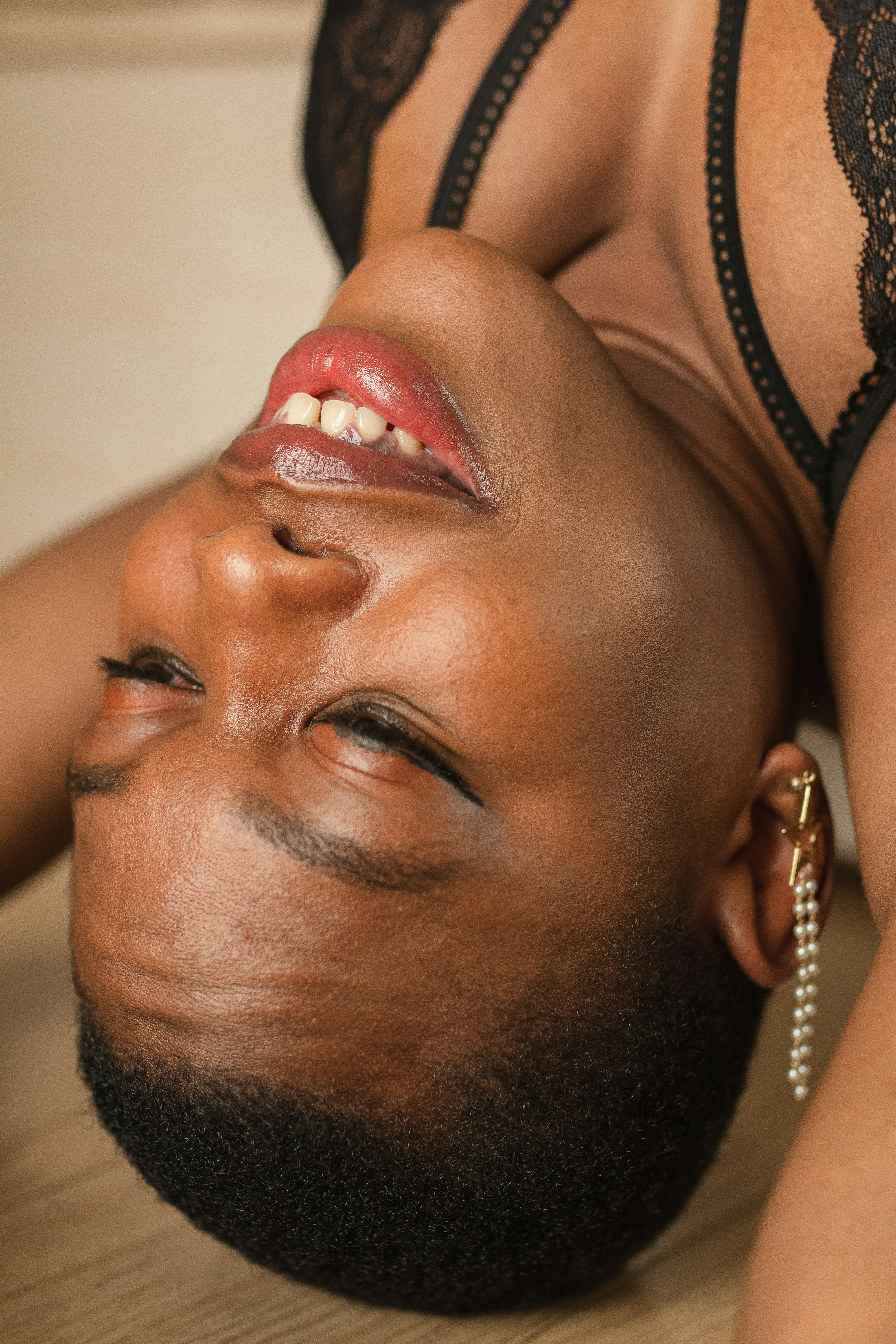 A woman with a thoughtful, slightly distant expression, looking out a window with soft, diffused light, symbolizing introspection and detachment.