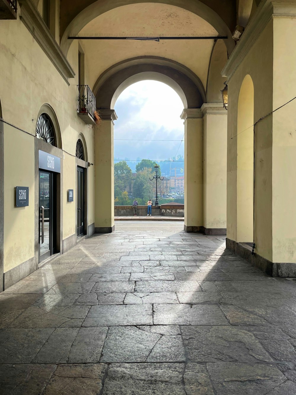 a stone walkway with a stone archway