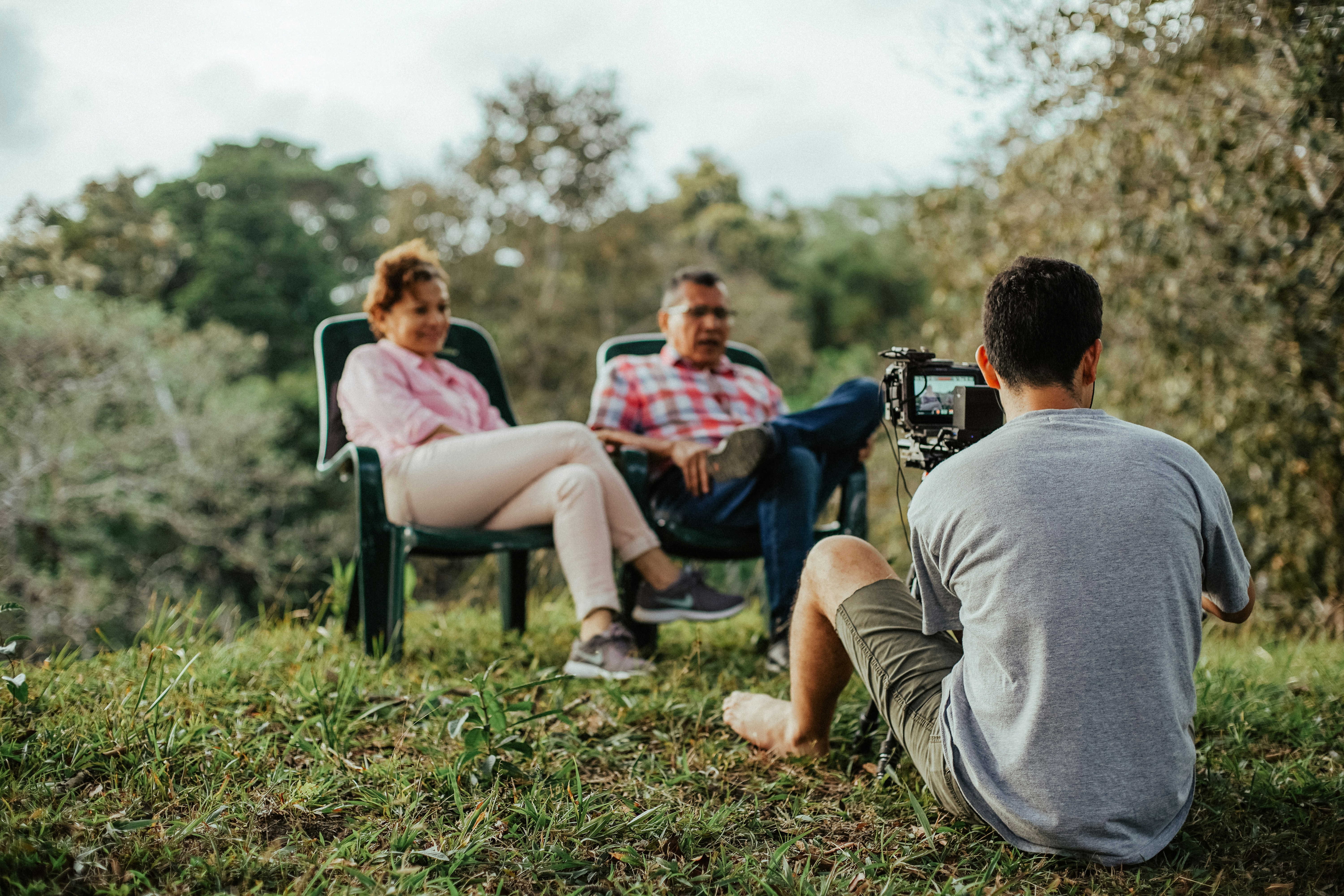 a group of people sitting in chairs outside