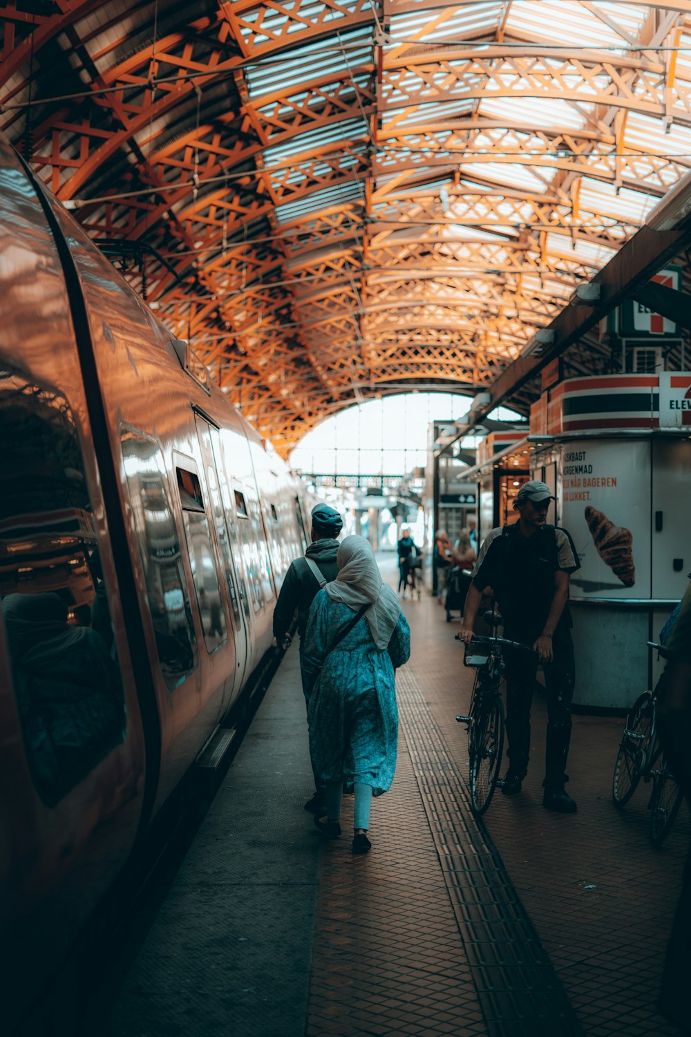 people walking on a train platform