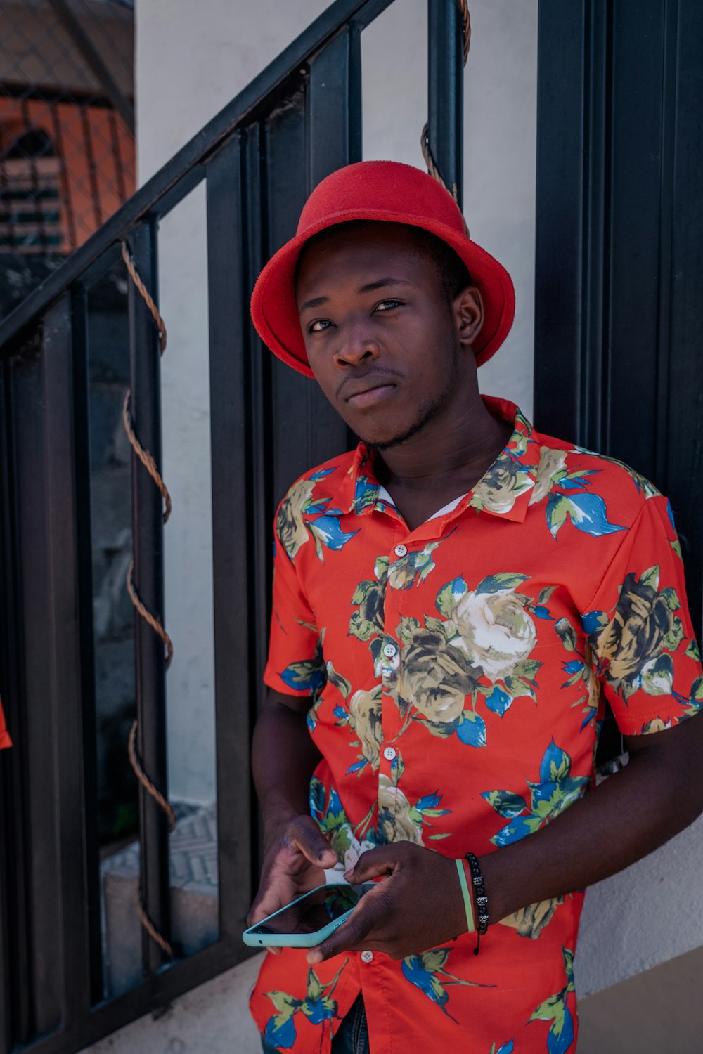 a person wearing a red hat and holding a cell phone