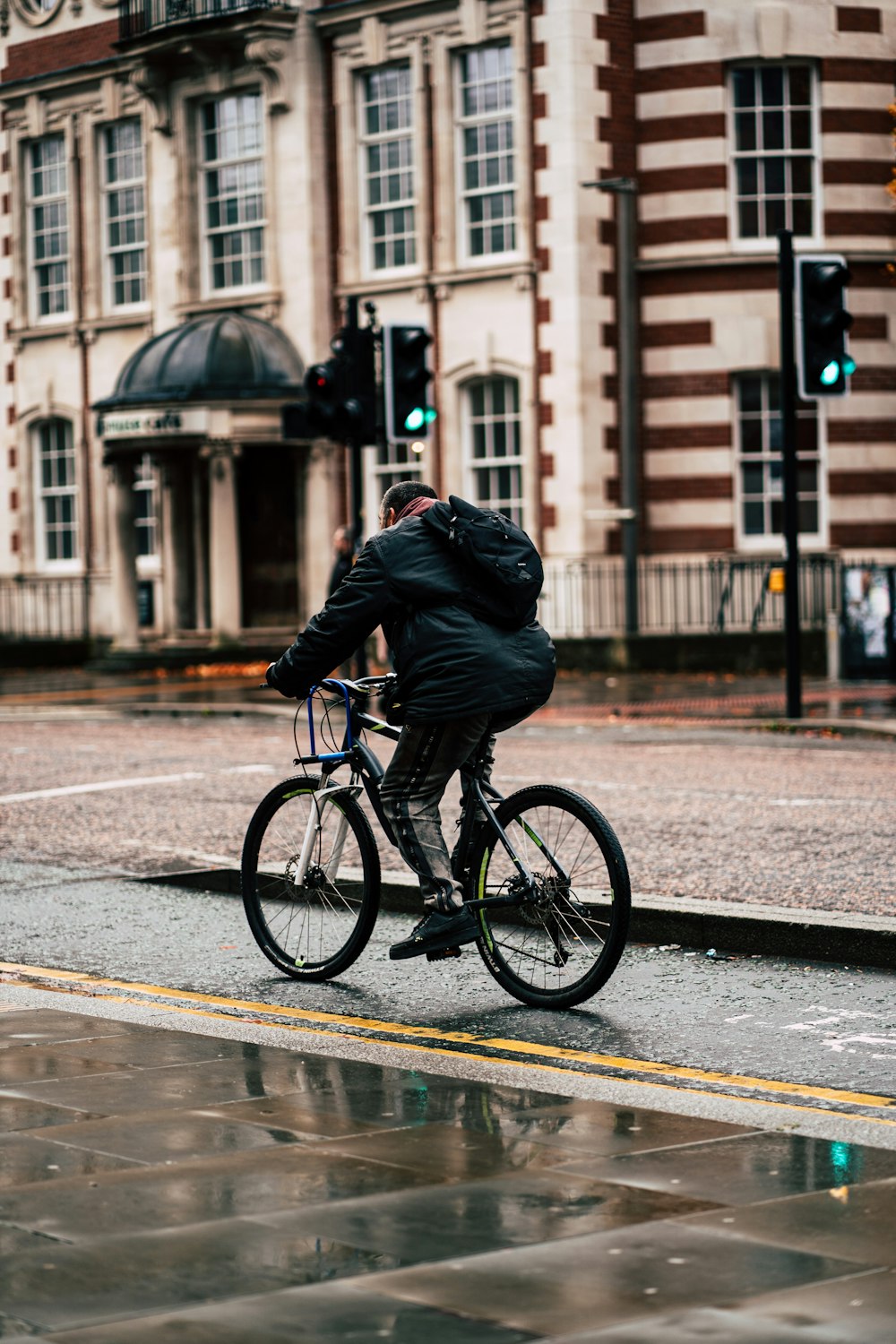 a person riding a bicycle on a wet street