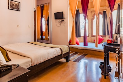a bedroom with a bed and a tv