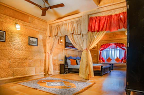 a bedroom with a bed and a fan