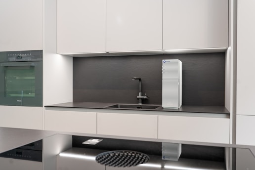 a kitchen with white cabinets: eco-friendly home products