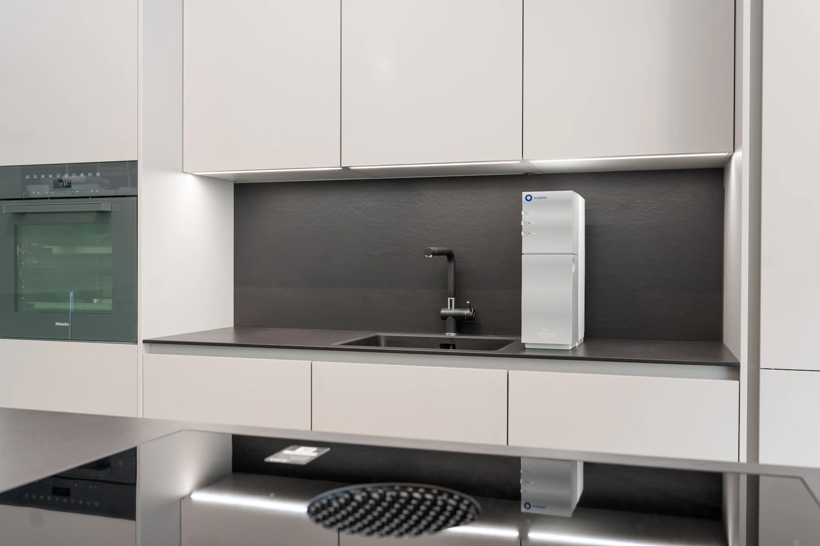 A compact water purification system in a modern kitchen