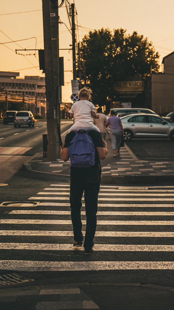 a woman walking across a crosswalk
