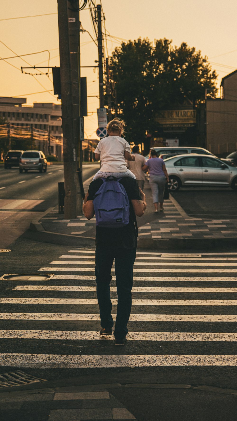 a woman walking across a crosswalk