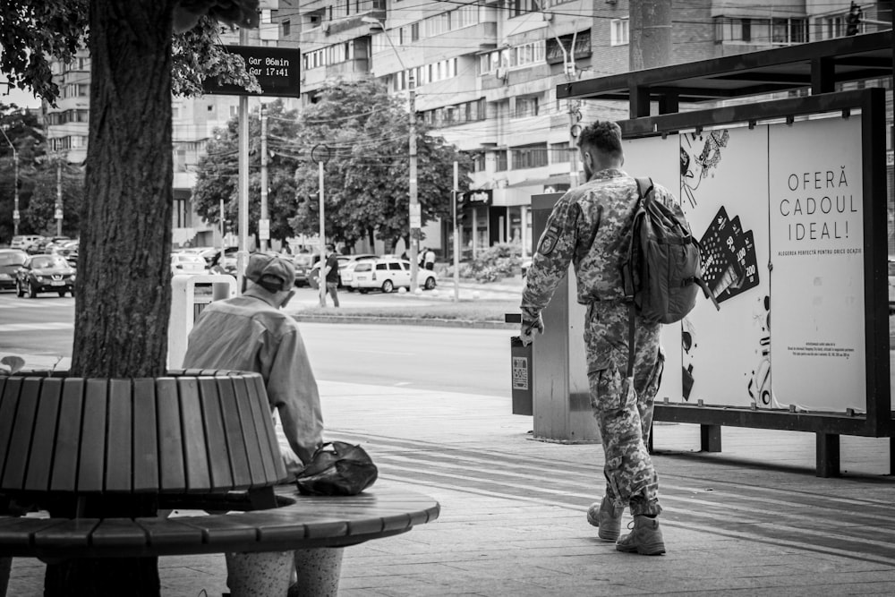 a person sitting on a bench next to a person sitting on a bench