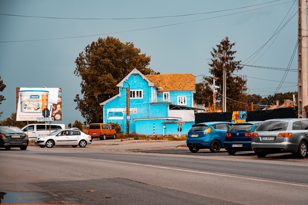 a group of cars parked in front of a blue building