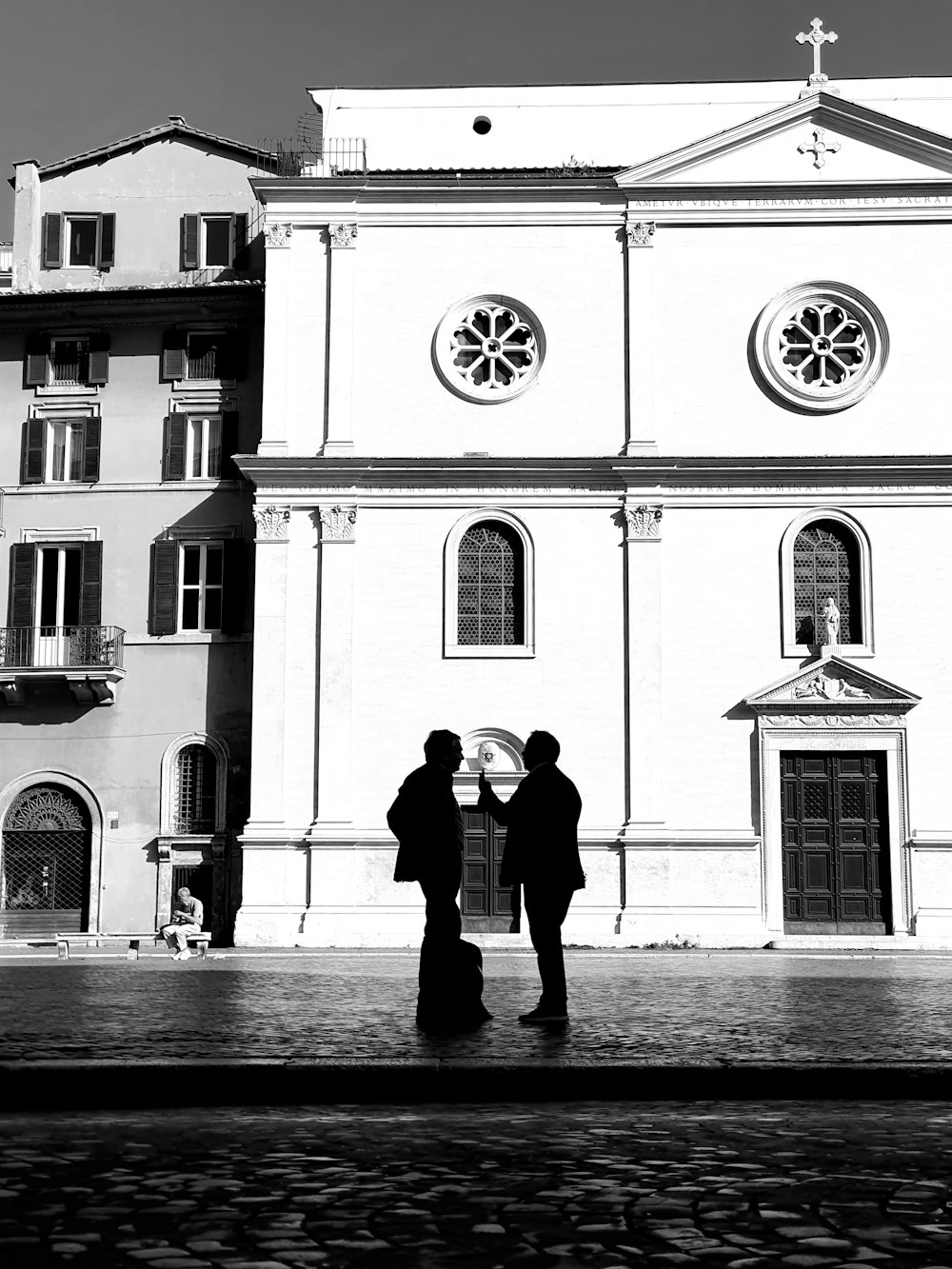 a couple of men standing in front of a church