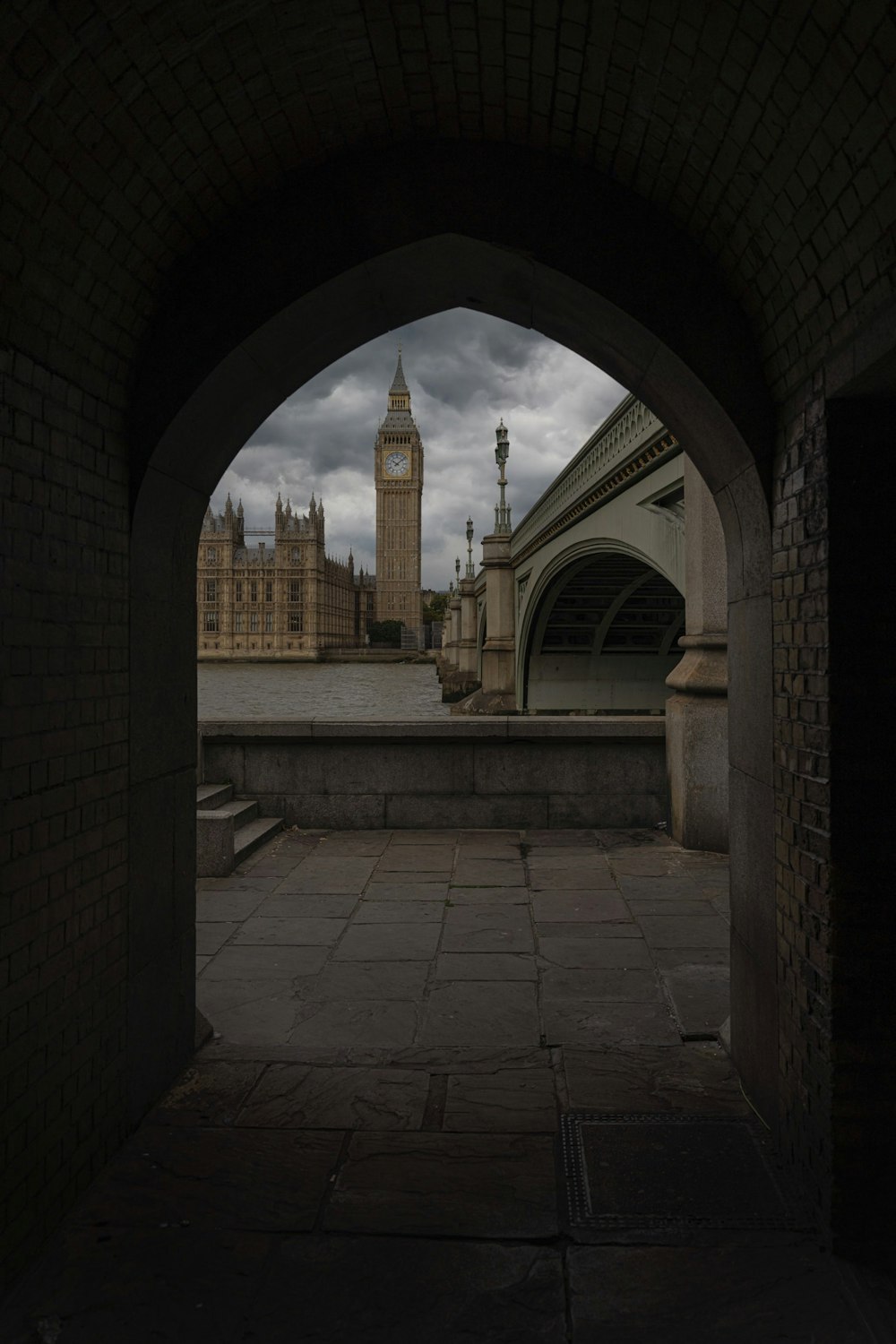 a stone walkway with a clock tower