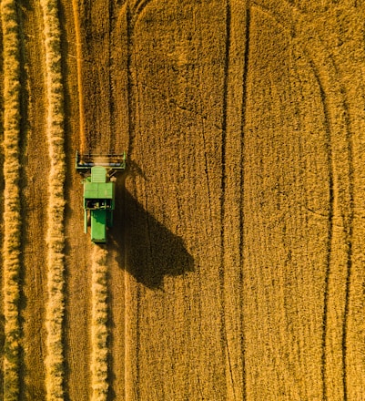 a green machine in a field of brown wheat
