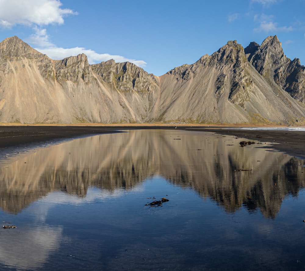 a body of water with mountains in the background